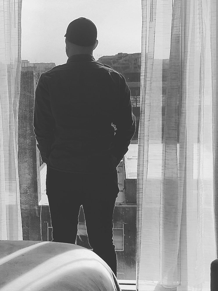 man looking out a window