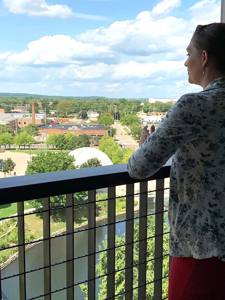 woman looking at view from a balcony